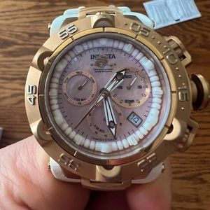 Invicta rose gold watch, light pink watch face, white band. great condition.